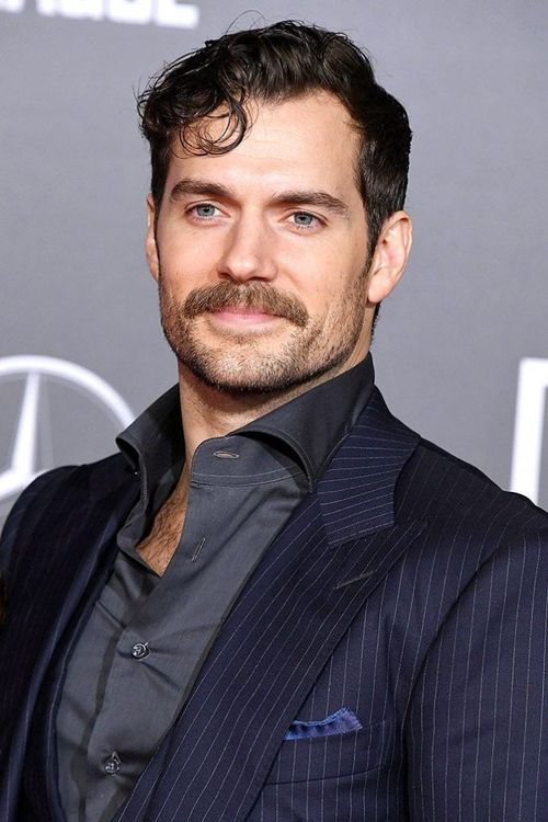 A bold chevron mustache with short stubble on the cheeks and jaw